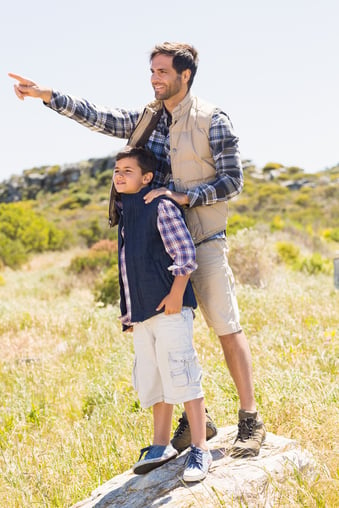 Father and son hiking in the mountains on a sunny day-1